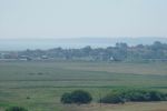 34: Looking across part of Southwold Common and the Town Marshes to the sea, where people are making the most of the day. 