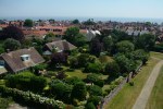 3: These lovely gardens with their lawns, shrubs and trees are bounded by a rose-filled hedge and attractive pebble-and-flint wall. 