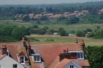 50: The countryside of inland Suffolk stretches away in the distance in the haze of a hot sunny day, as the Water Towers of Southwold Common come back into view.