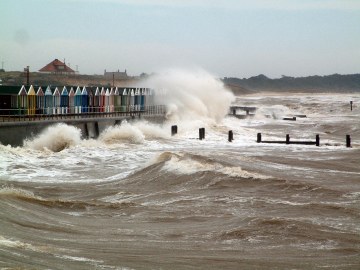 Heavy Seas breaking over the beach huts near the pier in July 2004
