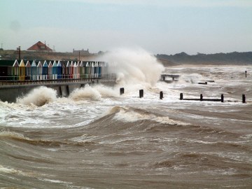 Heavy Seas breaking over the beach huts near the pier in July 2004 Heavy Seas breaking over the beach huts near the pier in July 2004